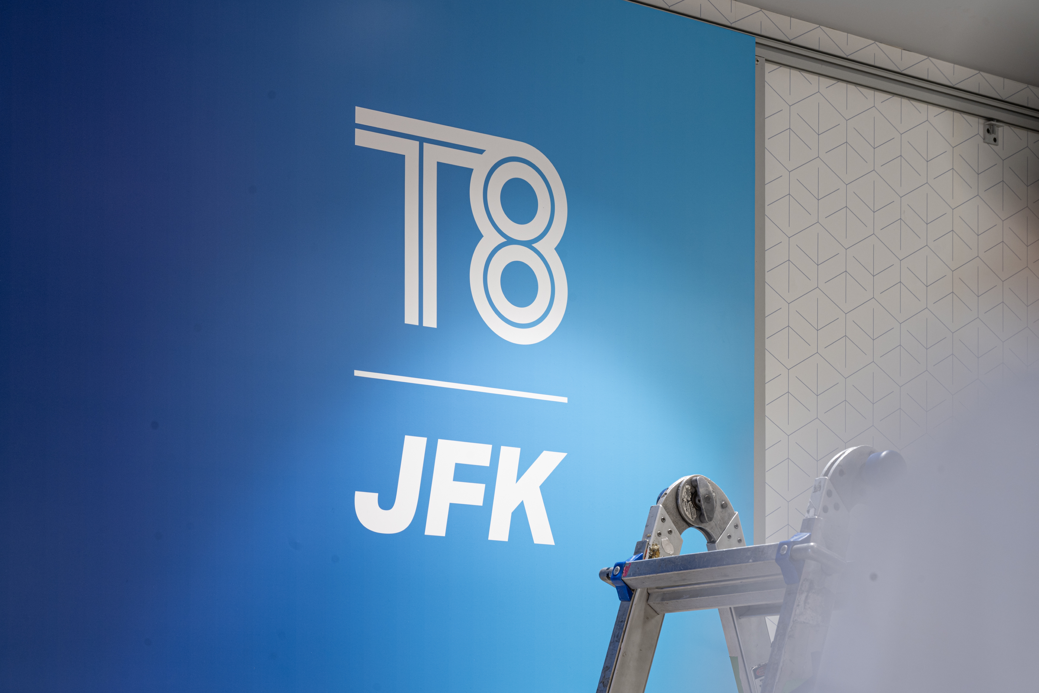 JFK T8 BTS Logo